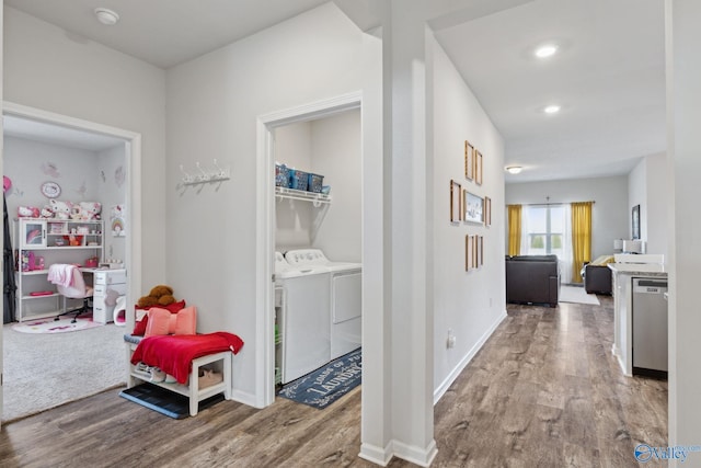 hallway with washer and dryer and light hardwood / wood-style floors