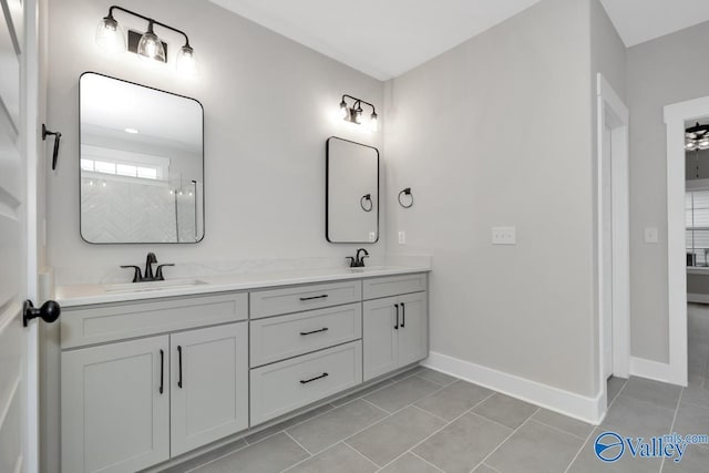 bathroom featuring a sink, baseboards, and tile patterned floors