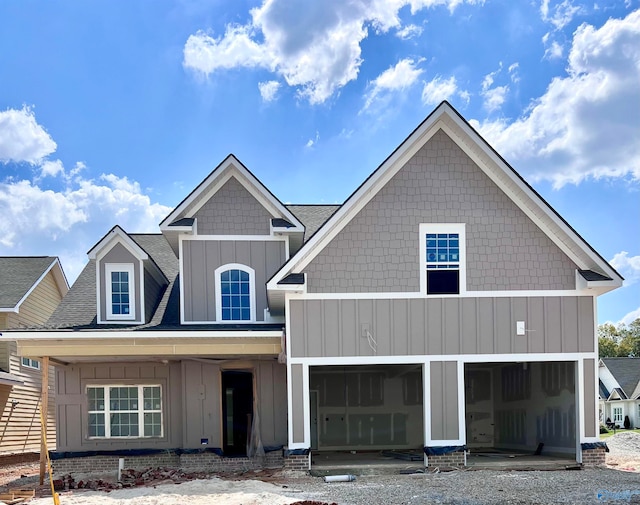 view of front of property featuring board and batten siding, a shingled roof, and an attached garage