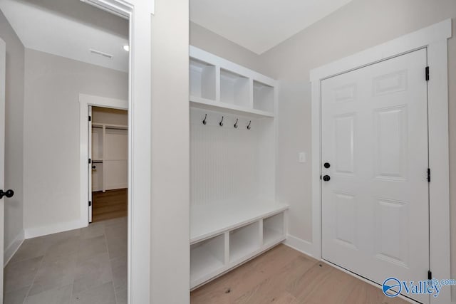 mudroom with visible vents, baseboards, and wood finished floors