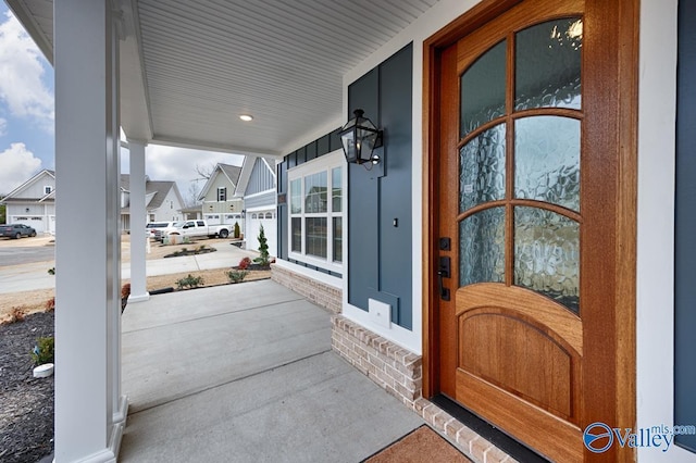 property entrance with covered porch and a residential view