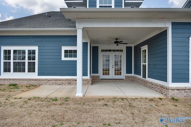 property entrance with a patio, ceiling fan, roof with shingles, french doors, and brick siding