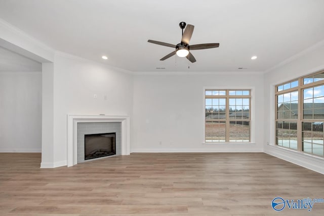 unfurnished living room with ornamental molding and light wood-type flooring