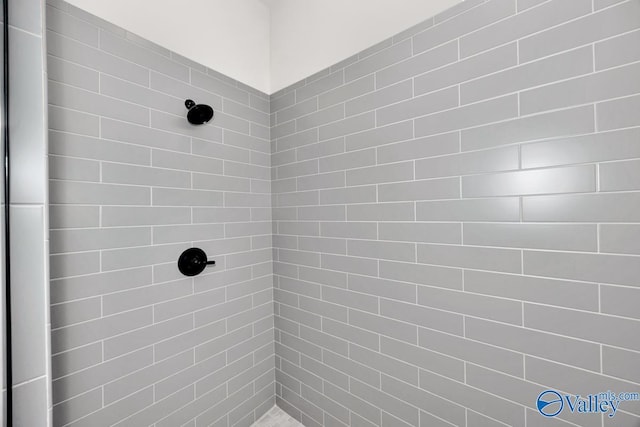 bathroom with tiled shower