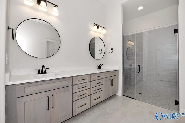 bathroom with vanity, an enclosed shower, and tile patterned floors