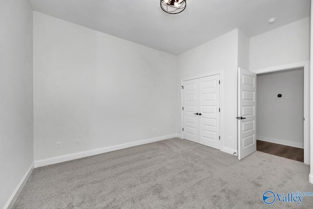 unfurnished bedroom with a closet and carpet