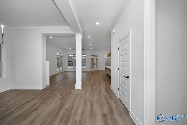 interior space featuring hardwood / wood-style flooring and ornate columns