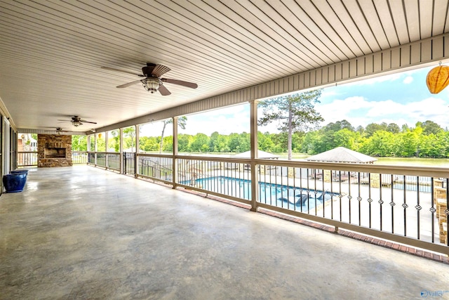 view of patio featuring ceiling fan and an outdoor pool