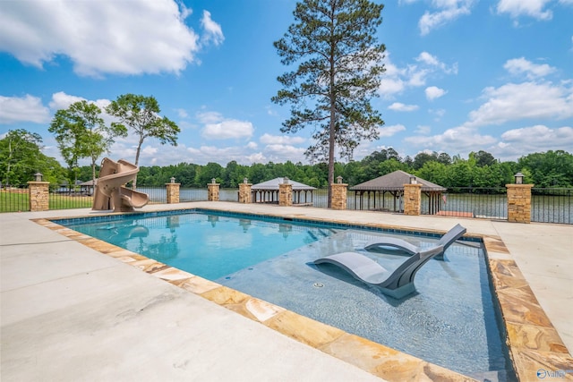 view of pool featuring a patio area, fence, a fenced in pool, a water slide, and a jacuzzi