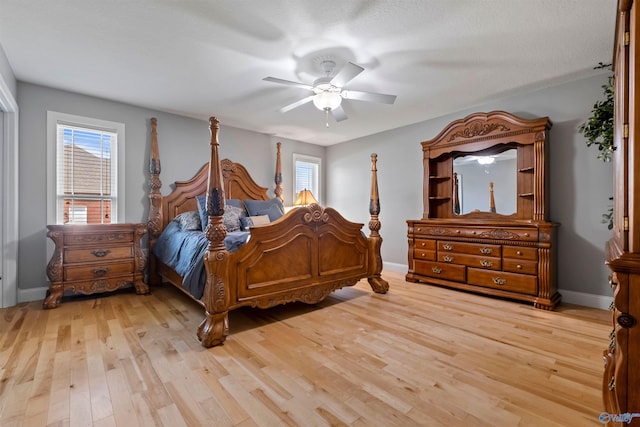 bedroom with baseboards, ceiling fan, and light wood-type flooring