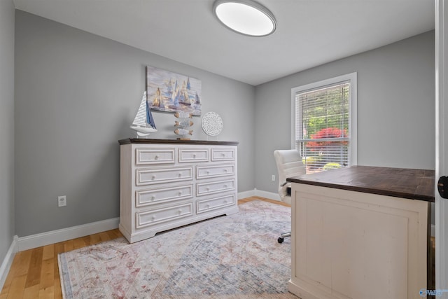 home office featuring baseboards and light wood-type flooring