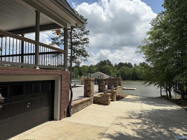 view of property exterior with a water view and brick siding