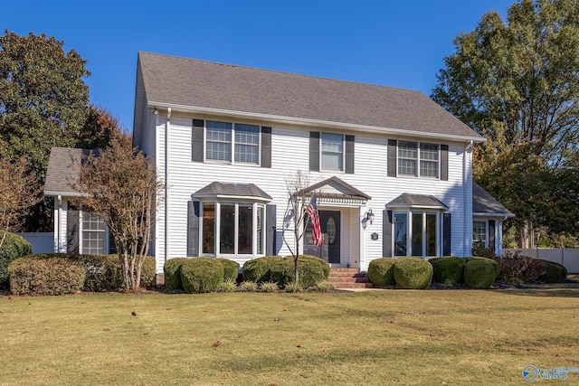 colonial inspired home featuring a front yard