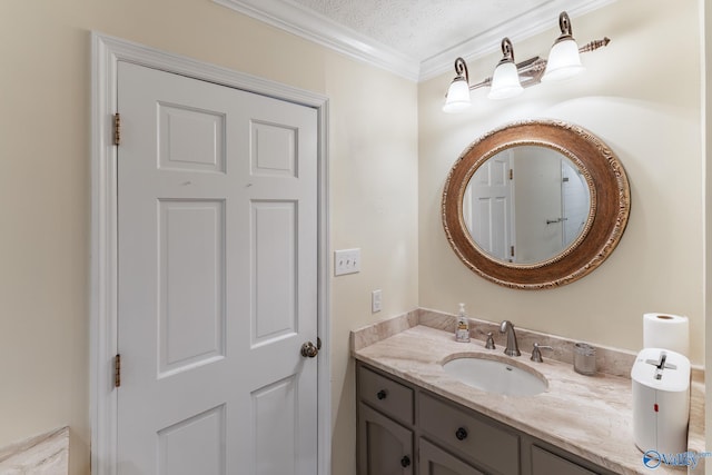 bathroom featuring vanity, a textured ceiling, and crown molding