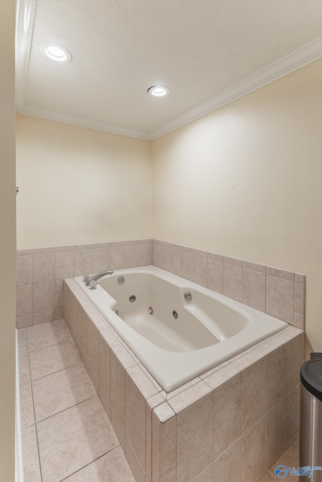 bathroom with tile patterned floors, a textured ceiling, crown molding, and tiled tub