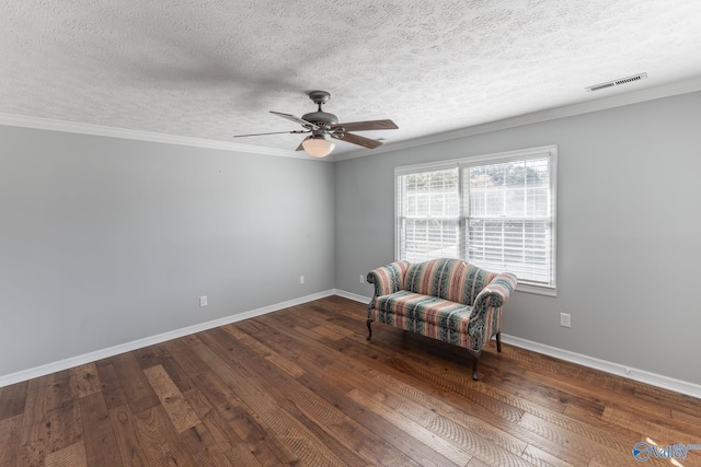 unfurnished room with crown molding, dark wood-type flooring, a textured ceiling, and ceiling fan