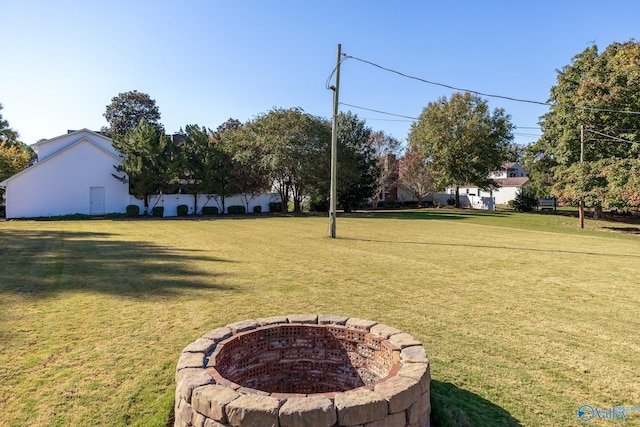 view of yard with a fire pit