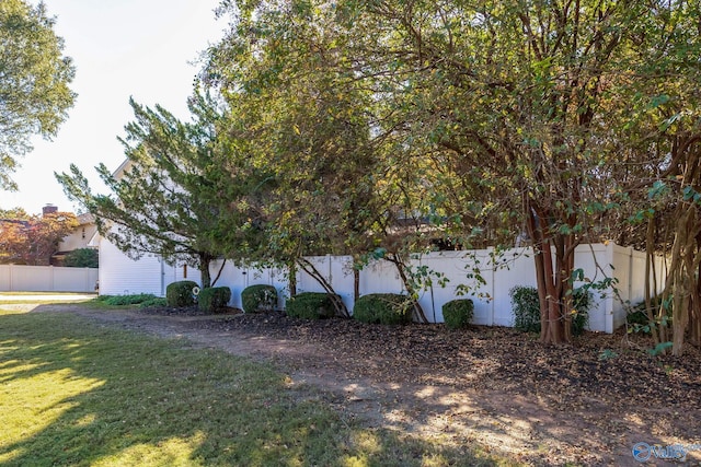 view of side of property with a lawn