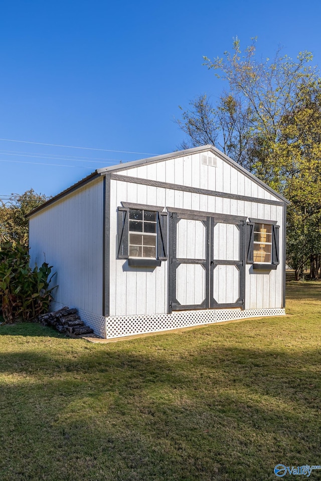 view of outbuilding with a lawn