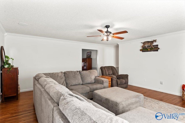 living room with crown molding, dark hardwood / wood-style floors, a textured ceiling, and ceiling fan