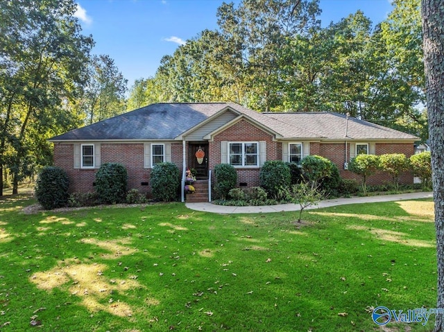 single story home featuring crawl space, a front lawn, and brick siding