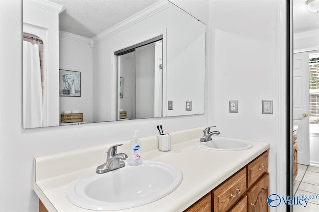 bathroom featuring vanity, crown molding, a textured ceiling, and tile patterned flooring