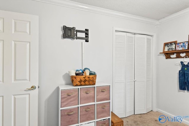 interior space with a textured ceiling, baseboards, light colored carpet, a closet, and crown molding