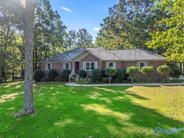 ranch-style house with brick siding and a front yard