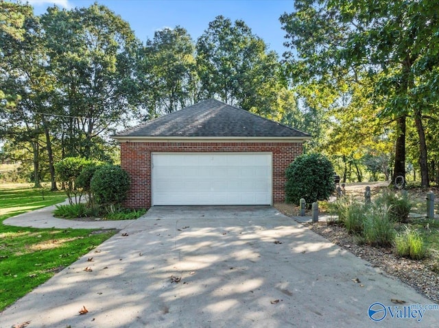 garage featuring concrete driveway