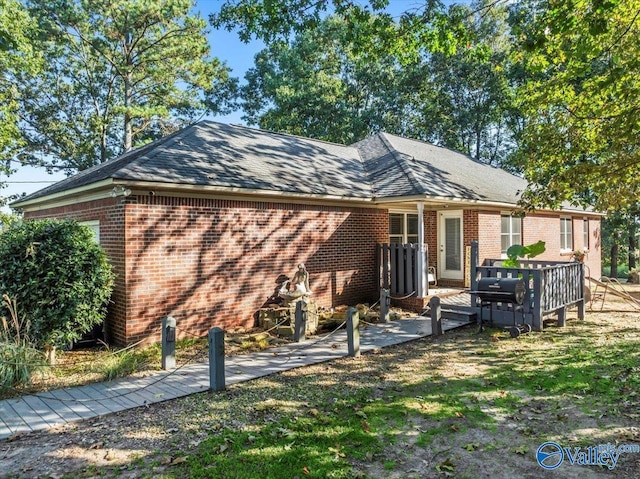 back of house with brick siding and an outdoor hangout area