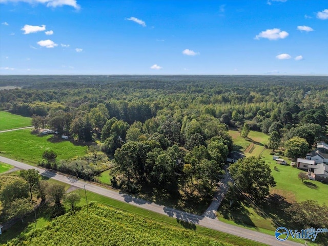 bird's eye view with a wooded view