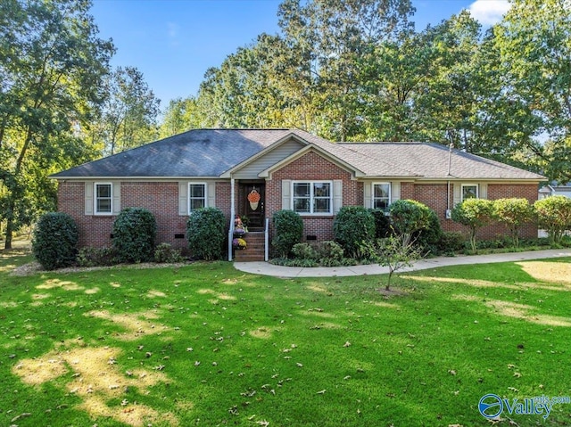 ranch-style home featuring brick siding, a front lawn, and crawl space
