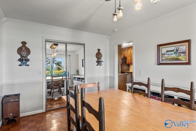 dining space with ornamental molding, a textured ceiling, and dark parquet flooring