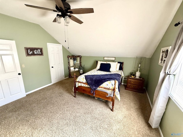 carpeted bedroom featuring baseboards, a ceiling fan, and vaulted ceiling