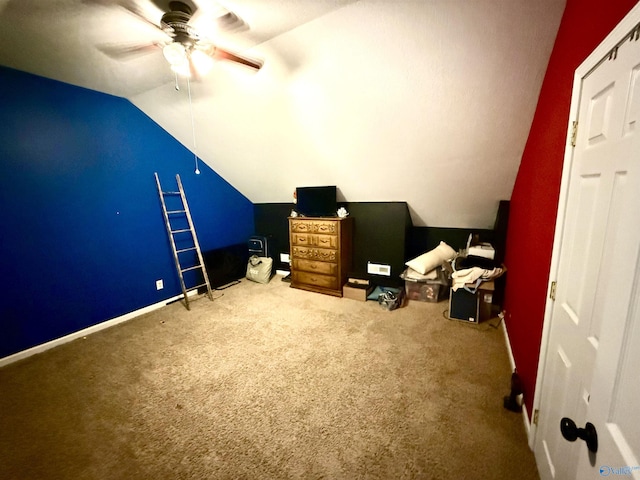 unfurnished bedroom with carpet flooring, ceiling fan, and vaulted ceiling