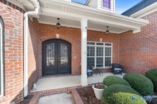 entrance to property featuring french doors and covered porch