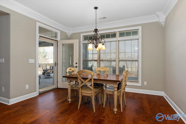 dining space featuring dark hardwood / wood-style floors, an inviting chandelier, and ornamental molding