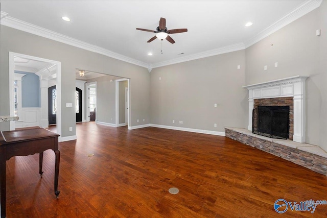 unfurnished living room with ceiling fan, a fireplace, dark wood-type flooring, and ornamental molding