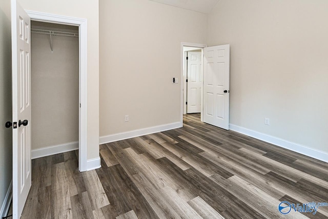 unfurnished bedroom featuring a closet and dark hardwood / wood-style floors