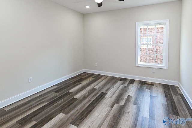 empty room with dark hardwood / wood-style flooring and ceiling fan