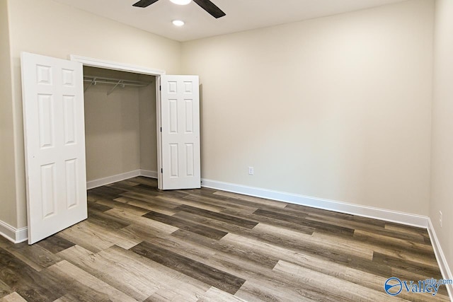 unfurnished bedroom with a closet, ceiling fan, and dark hardwood / wood-style flooring