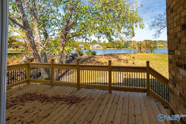 wooden terrace featuring a water view