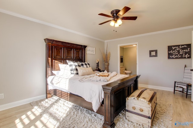 bedroom featuring crown molding, ceiling fan, light wood-type flooring, and ensuite bath