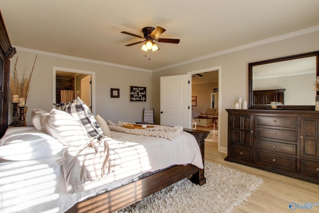 bedroom featuring light hardwood / wood-style flooring, ornamental molding, and ceiling fan