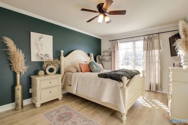 bedroom featuring ceiling fan, ornamental molding, and light hardwood / wood-style floors