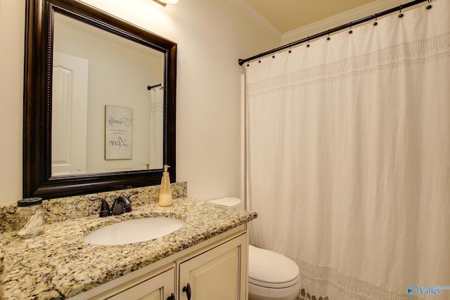 bathroom featuring vanity, ornamental molding, and toilet