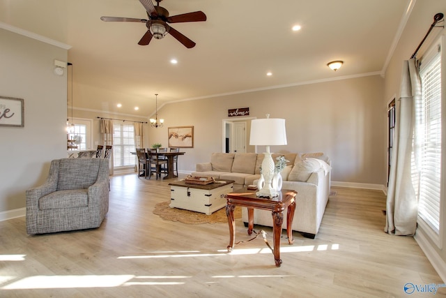 living room with crown molding, ceiling fan with notable chandelier, and light wood-type flooring