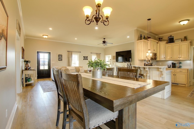 dining room with crown molding, ceiling fan with notable chandelier, and light hardwood / wood-style floors