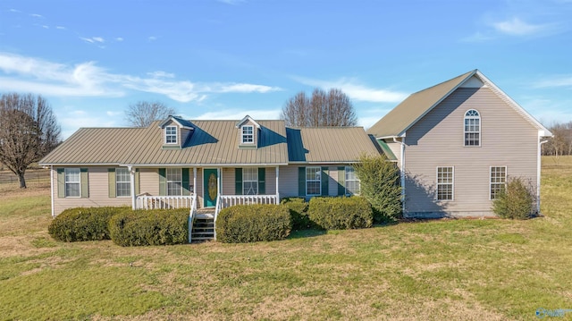 cape cod house with a front lawn and covered porch