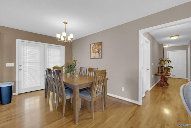 dining room featuring a chandelier and light hardwood / wood-style floors